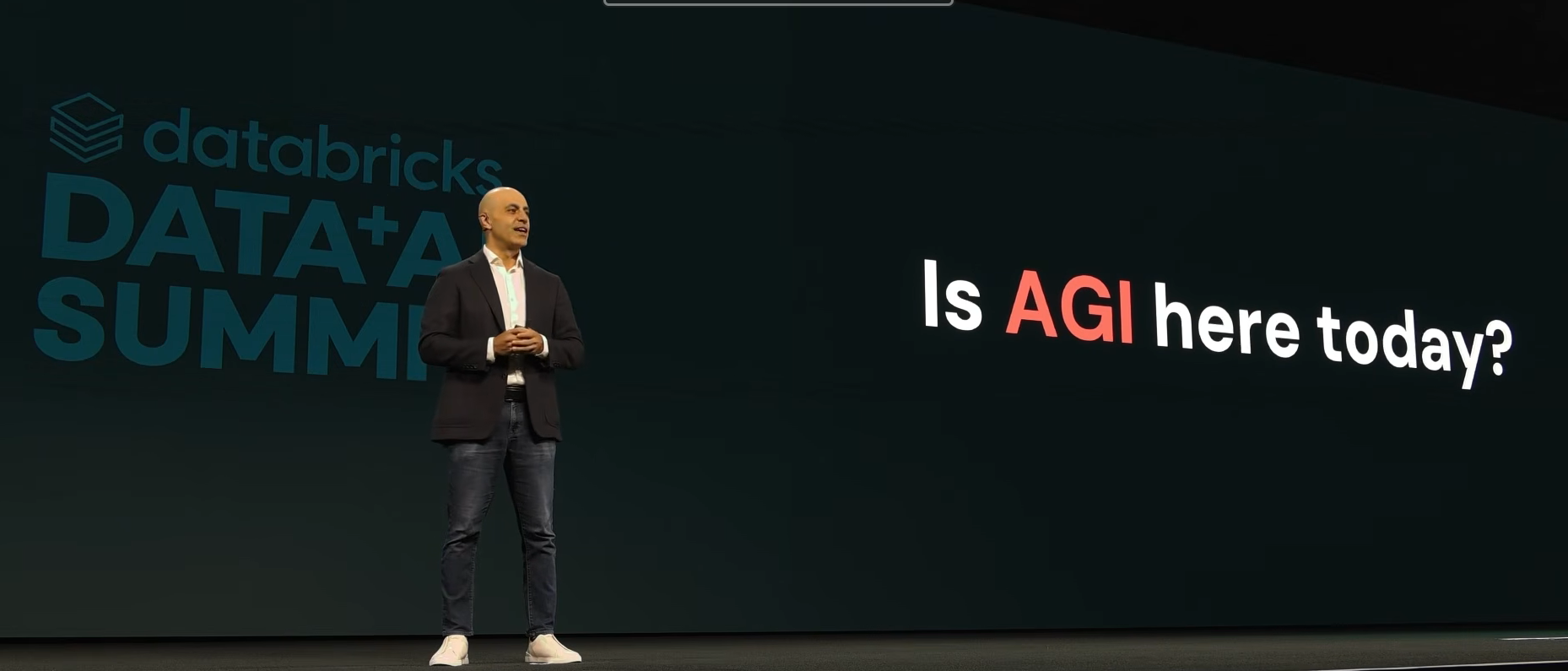 Ali Ghodsi polling the audience at Databricks Data + AI Summit 2026 on whether AGI has already arrived